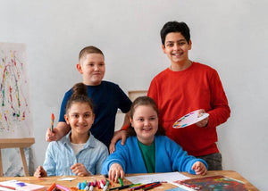Teens taking a photo together in splatter room, surrounded by their colorful artworks.