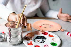 Kid preparing painting tools, ready to start an art project.